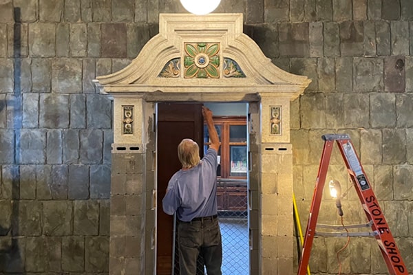 Crew member working on archway in the City Museum